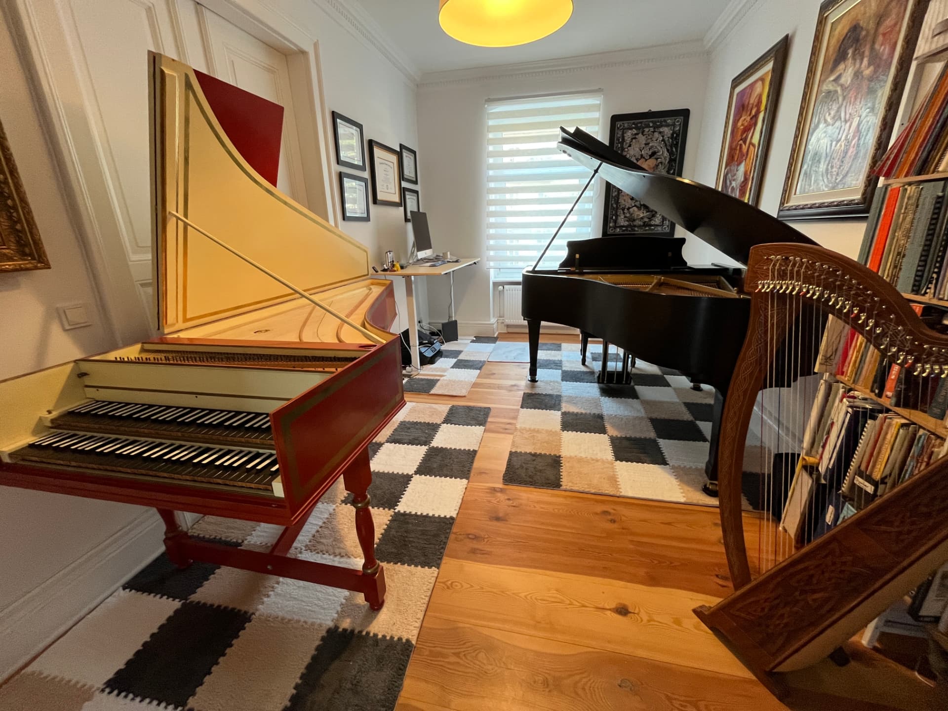 Harpsichord, grand, and harp share one warm, wood-floored salon in central Berlin.