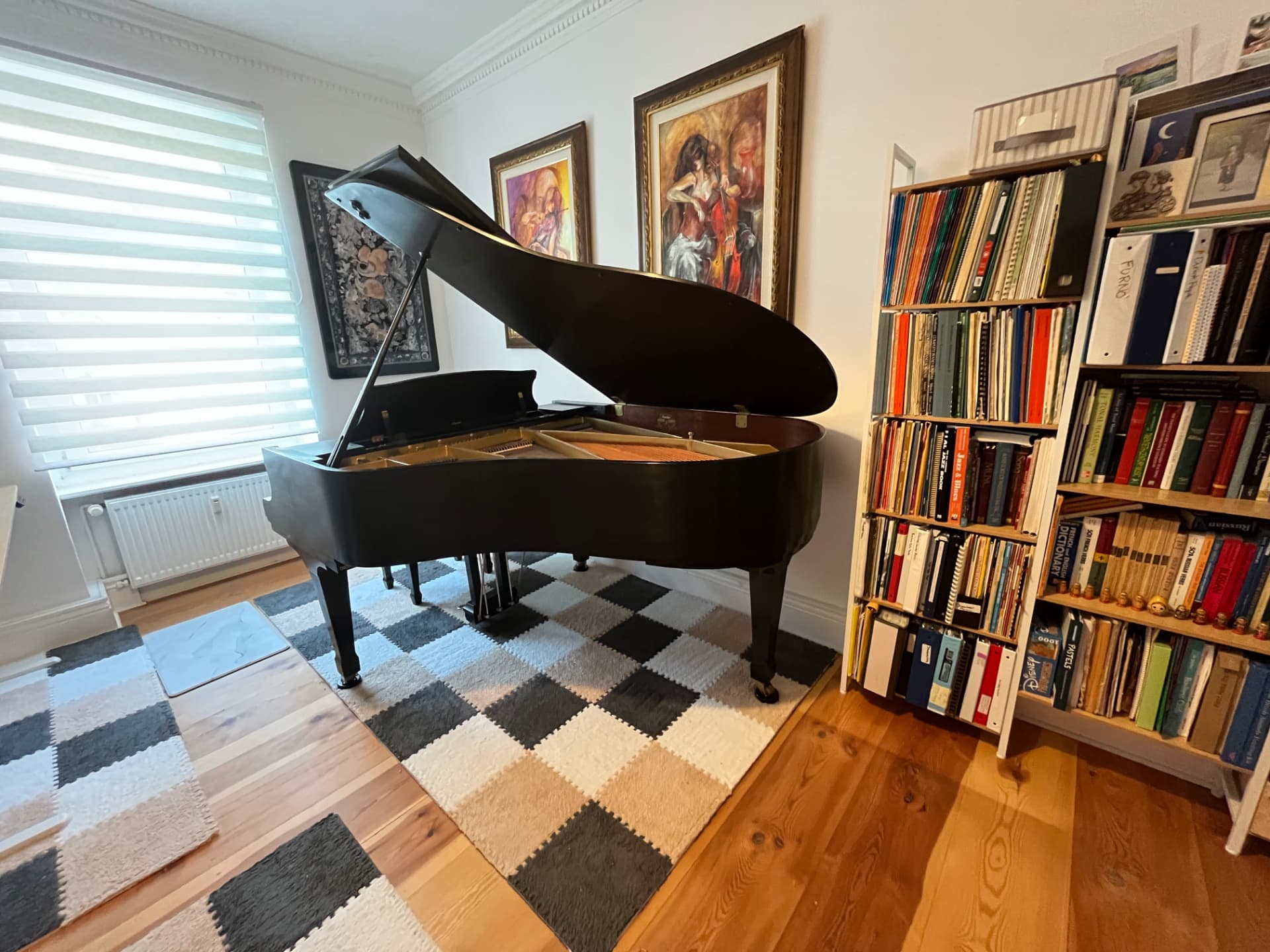 The Kawai grand in the light of the atelier's tall windows, where lessons and salon evenings take place.